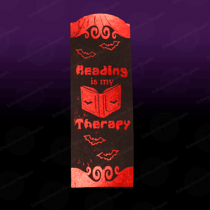 Lesezeichen mit Text "Reading is my therapy" in schwarz mit roter Folierung