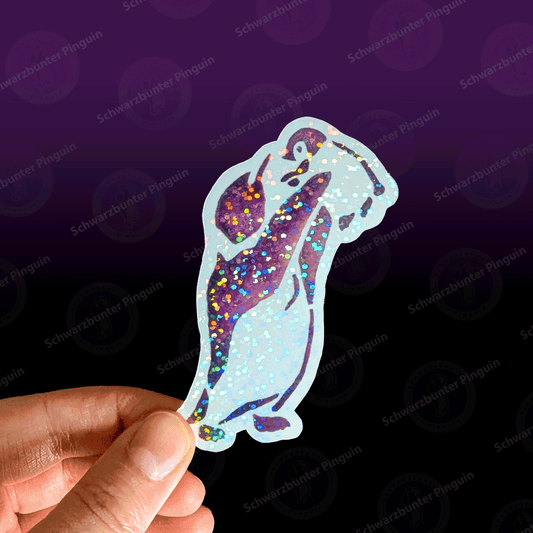 Glitzernder Schwarzbunter Pinguin Sticker mit zwei lila farbigen Pinguinen